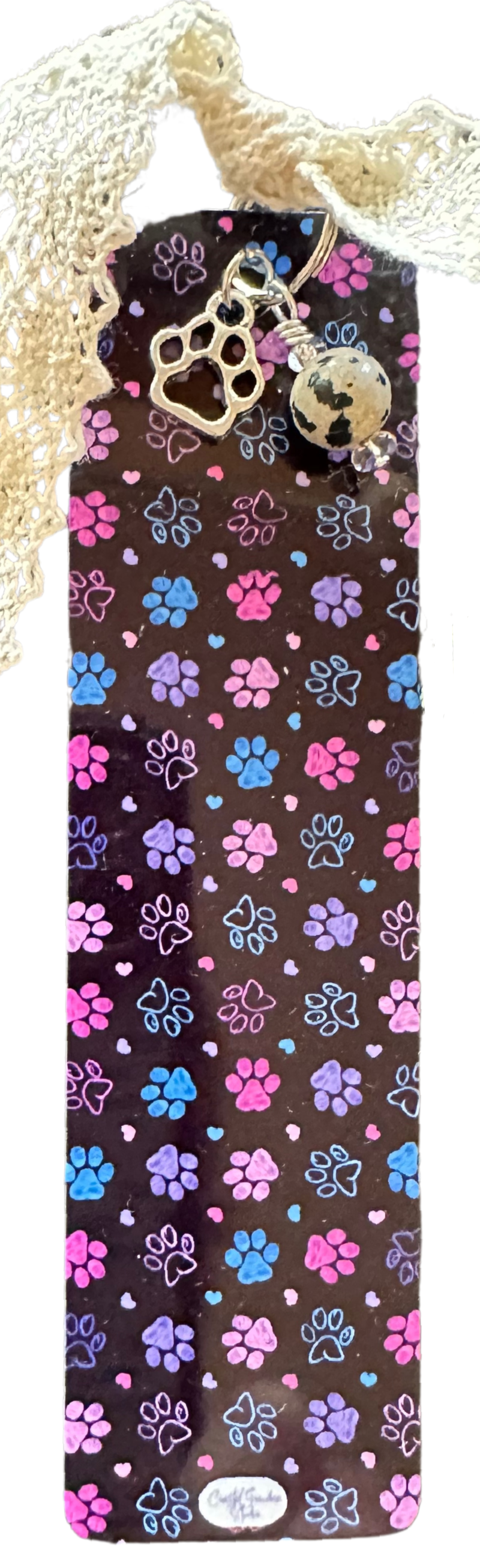 Designed with a lightweight aluminum base, this cute aesthetic bookmark features a delicate emetal paw print charm, a Dalmatian jasper bead charm, and a soft cotton lace ribbon for a touch of shabby, yet chic charm.